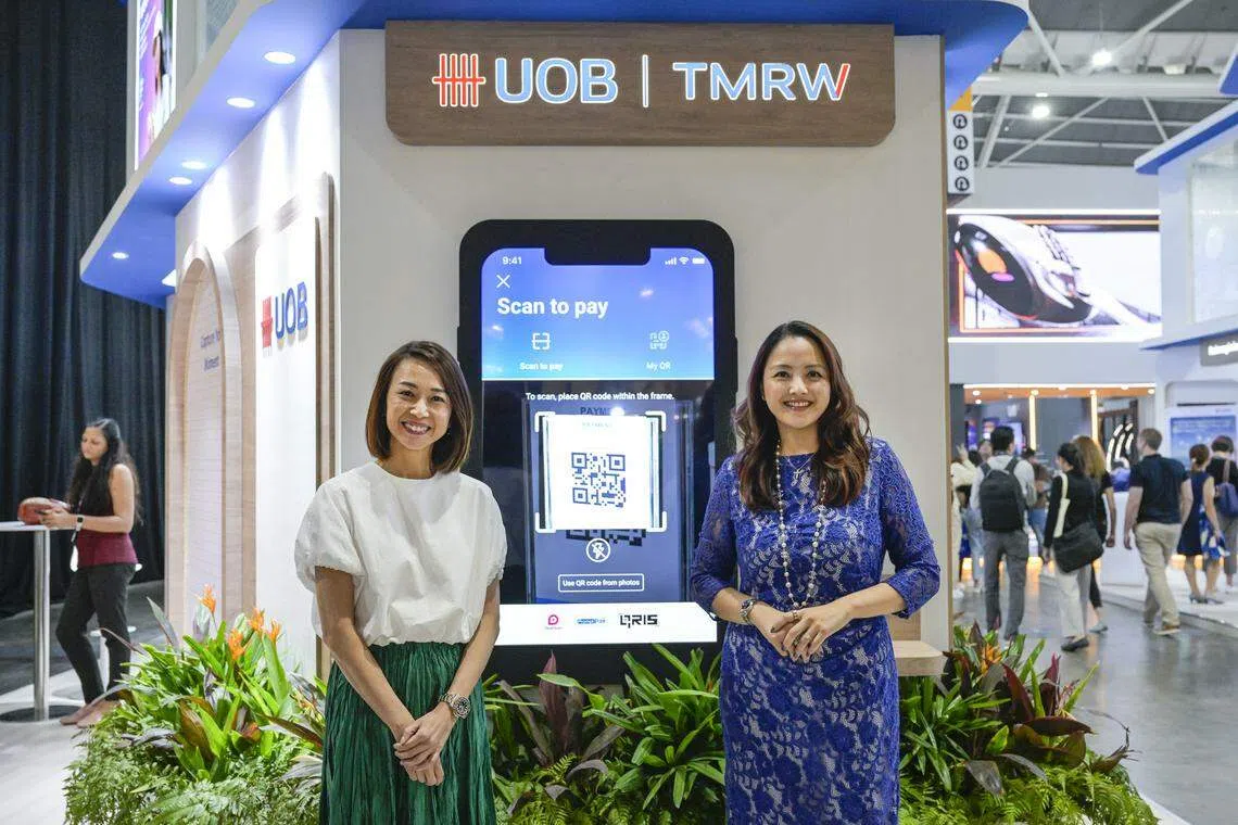 From left: Choo Wan Sim, head of UOB TMRW Digital (Singapore) and Jacquelyn Tan, head of group personal financial services, showcasing the "scan to pay" feature on UOB TMRW App. UOB customers in Singapore can now use the function to make payments in Malaysia, Thailand and Indonesia. 