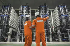 pixkeppel - Keppel provides solutions for sustainable urbanisation. The picture depicts staff at the Keppel Marina East Desalination Plant inspecting the filtration membranes used in the water treatment process.