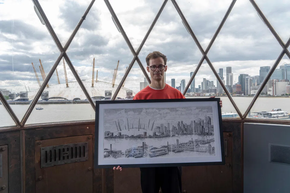 James Cook produces his work in a studio in London, surrounded by typewriters and artwork, with the white dome of the O2 arena visible outside. 