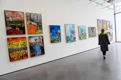 A woman visits the exhibition of 24 paintings by US singer Bob Dylan entitled "Drawn Blank", at Chateau La Coste Art Center in Le Puy-Sainte-Reparade, southeastern France, on May 5, 2022. 