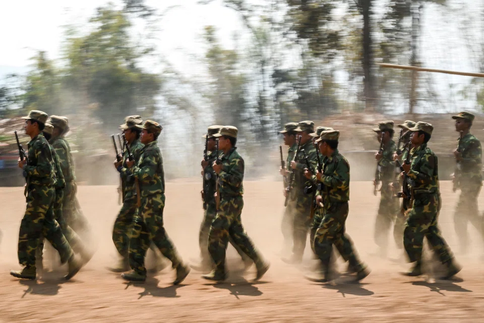 Members of ethnic rebel group Ta'ang National Liberation Army taking part in a training exercise at their base camp in the forest in Myanmar's northern Shan State. At least 1.2 million people have been displaced by post-coup fighting, according to the United Nations.