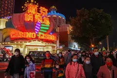 People walk past the Casino Lisboa operated by SJM Holdings during Lunar New Year in Macau, China, Jan 24, 2023.