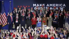 Former US president Donald Trump (left) takes the stage with New Hampshire Republican leaders, before addressing a crowd during a rally in Manchester, New Hampshire, USA, April 27, 2023.  