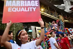 A member of the LGBTQ community holds a placard calling for marriage equality during a pride march in Bangkok on June 4, 2023. The Thai Senate passed the first reading of a Bill to legalise same-sex marriage.
