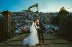 Iris Hsueh and her fiance Ian Ciou posing for a photograph in front of a garbage hill in Puli Township, Nantou County. 