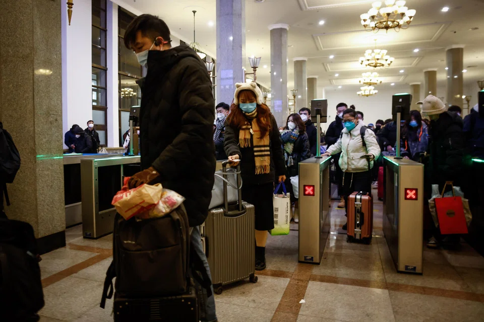 Passengers prepare to board a train bound for Jilin province at the Beijing railway station, Beijing, China, Jan 14, 2023.