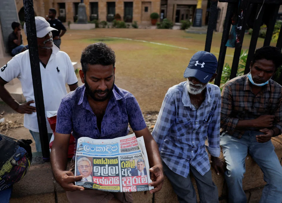 A man folds a newspaper after reading the news about the resignation of President Gotabaya Rajapaksa who fled to Singapore amid Sri Lanka's economic crisis, in Colombo, Sri Lanka. The speaker of parliament in crisis-hit Sri Lanka has accepted a resignation letter from President Gotabaya Rajapaksa,

