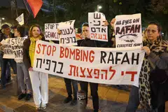 Demonstrators gather with signs during a protest outside the Kirya military base which houses the Defence Ministry in Tel Aviv, Israel, Feb 13, 2024.