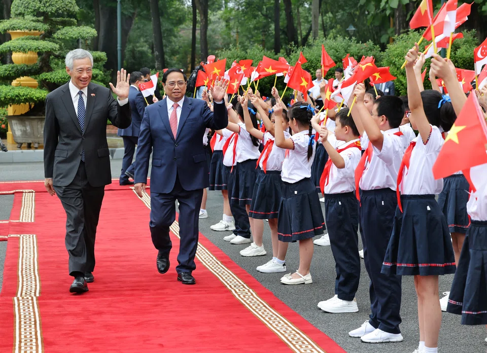 Prime Minister Lee Hsien Loong was welcomed by Vietnamese Prime Minister Pham Minh Chinh at the Presidential Palace in Hanoi on Monday.