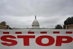 A traffic barrier is seen front of the dome of the US Capitol as a government shutdown looms in Washington, DC on Sept 28, 2023. 