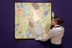 The final price of Lady With A Fan (pictured) topped Gustav Klimt’s previous auction high of US$104.6 million, given in November for the 1903 landscape Birch Forest.