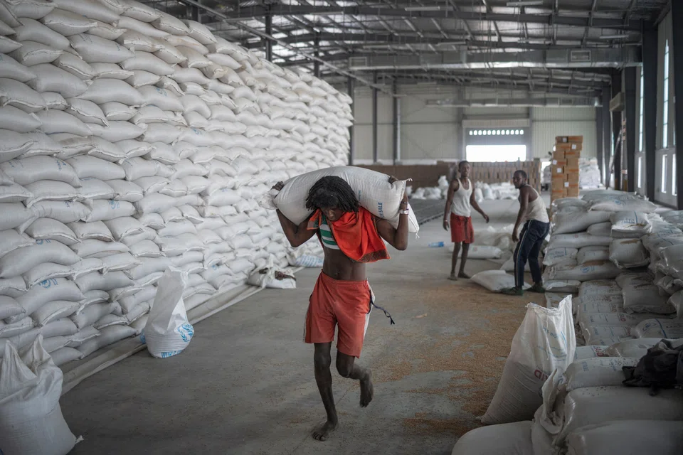 A man carries a bag of wheat to be loaded on an aid truck in a UN storehouse on the outskirts of Semera, Afar region, Ethiopia. The Tigray People’s Liberation Front (TPLF) dominated Ethiopia’s ruling coalition for decades before Abiy Ahmed took power in 2018.