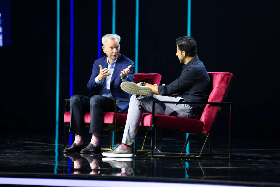 Former Google CEO Eric Schmidt (left, with Databricks co-founder Arsalan Tavakoli) warns that AI could be used by bad actors to "accelerate at scale".