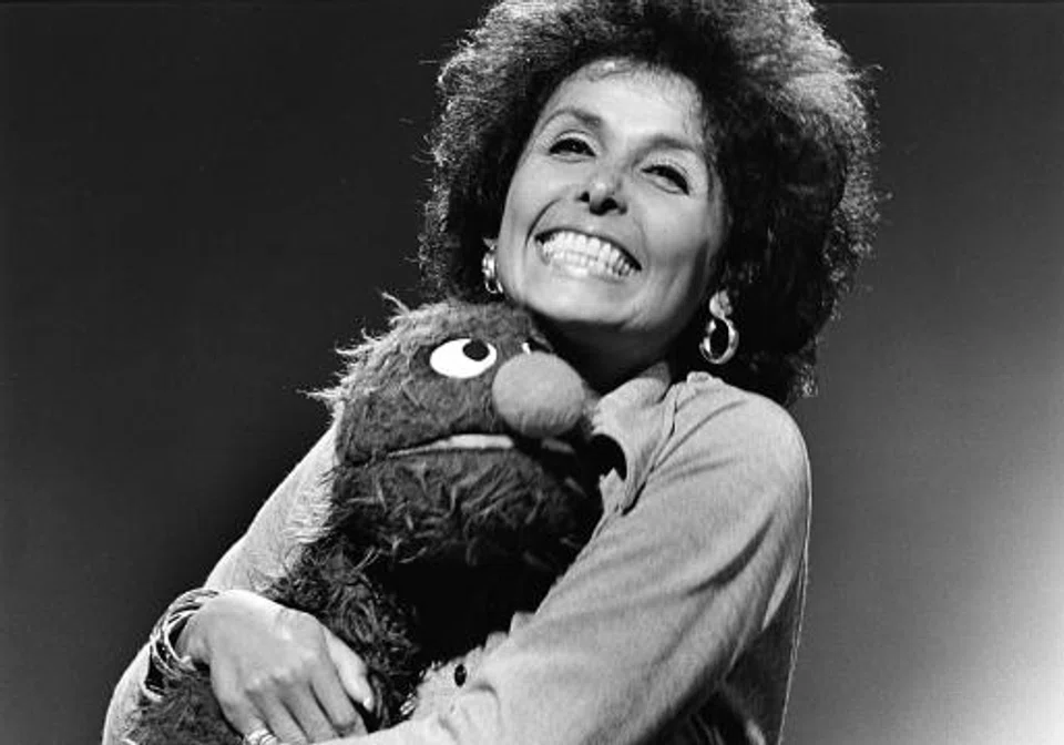 In this 1973 photo, singer Lena Horne embraces the character Grover on during an appearance on the children's program "Sesame Street," in New York. 