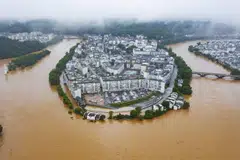Flooded streets and buildings following heavy rains in Wuyuan, in China's central Jiangxi province on June 20, 2022.