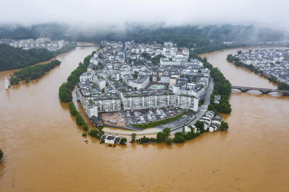 This aerial photo taken on June 20, 2022 shows flooded streets and buildings following heavy rains in Wuyuan, in China's central Jiangxi province. 