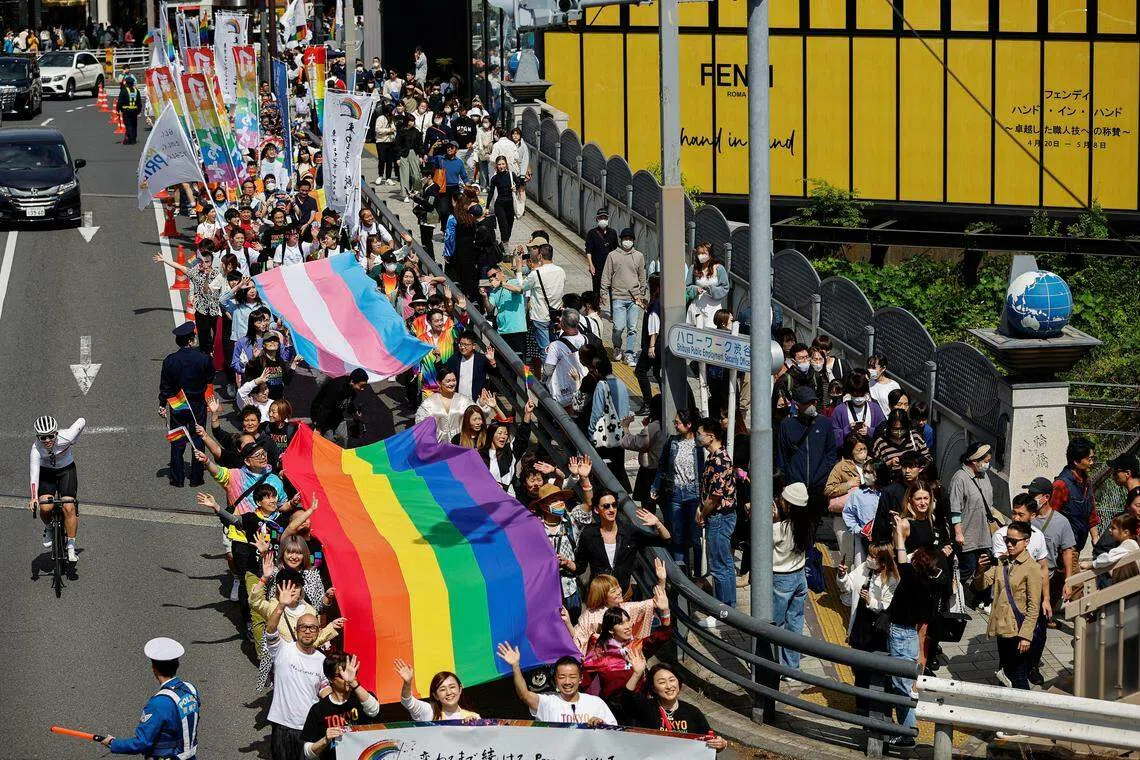 Participants at the Tokyo Rainbow Pride parade (top). The debate whether Japan’s laws against same-sex marriage are unconstitutional has split lower courts, with one district court holding the bar to be constitutional but others saying it is unconstitutional in varying degrees.