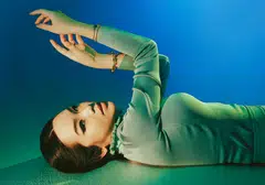 Willabelle Ong in olive green knitted pullover by Hermes. 