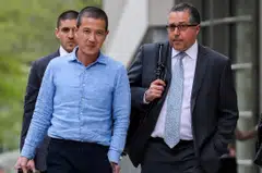 Ex-Goldman Sachs banker Roger Ng (left) and his lawyer  leaving the federal court in New York on May 6, 2019; it’s unclear how long Ng will be in Malaysia, where he also faces four charges