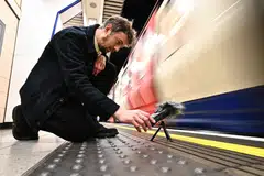 Stuart Fowkes recording the sound of a passing London Underground train at Blackfriars tube station in London; to him, there is nothing dull or uninteresting about the screeching of the train’s wheels scraping against the curves in the metal tracks or the clunk of the doors opening and closing.