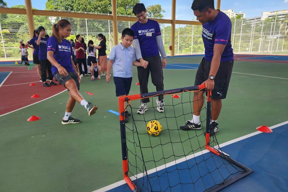 Volunteers from SGX Cares with students from AWWA School @ Bedok.