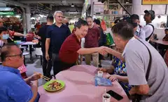 Presidential hopeful Tan Kin Lian (centre) meeting residents at Jurong West 505 Market and Food Centre on Aug 15, 2023. 