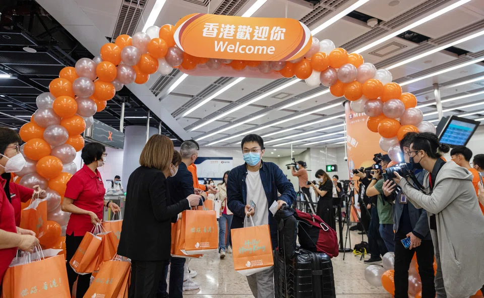 Travellers from mainland China are presented with welcome gifts from the Hong Kong Tourism Board after arriving at the West Kowloon station in Hong Kong, Jan 15, 2023. 