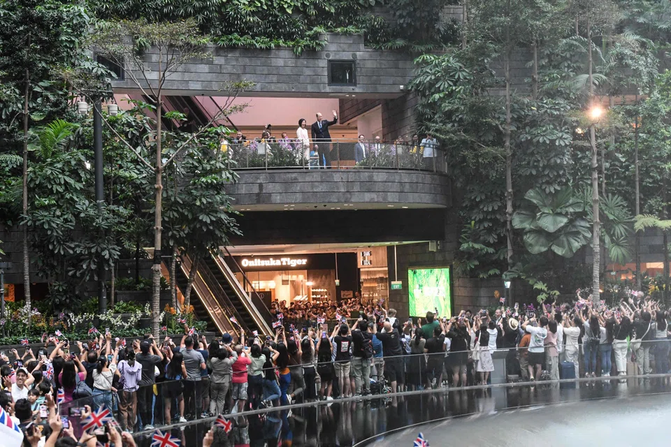 Prince William, accompanied by Senior Minister of State for Foreign Affairs Sim Ann, greeting people at Jewel Changi Airport shortly after his arrival on Sunday.