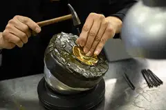 A jewellery craftsman working on a gold piece at the Chow Tai Fook master studio in Foshan, China, Jan 26, 2024. 