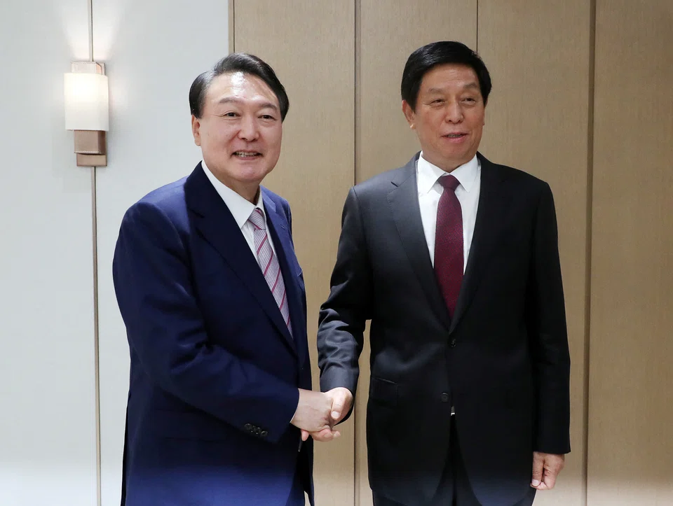 China's top legislator, Li Zhanshu (right) was met with South Korean President Yoon Suk-yeol, who is seeking to maintain economic ties with Beijing.