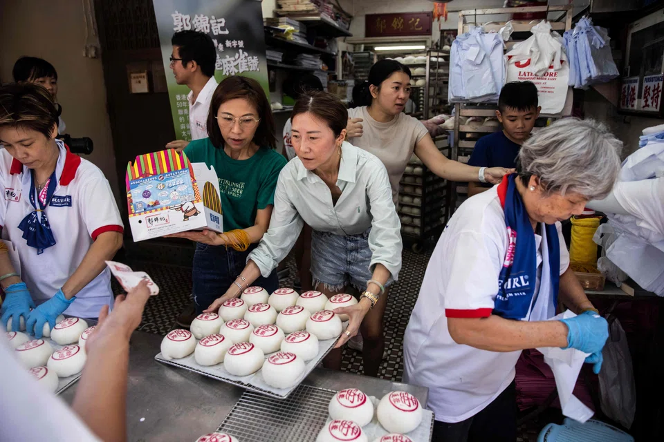 Shops such as the popular Kwok Kam Kee bakery see long queues of festivalgoers eager to sample the Cheung Chau island's favorite sweet buns.