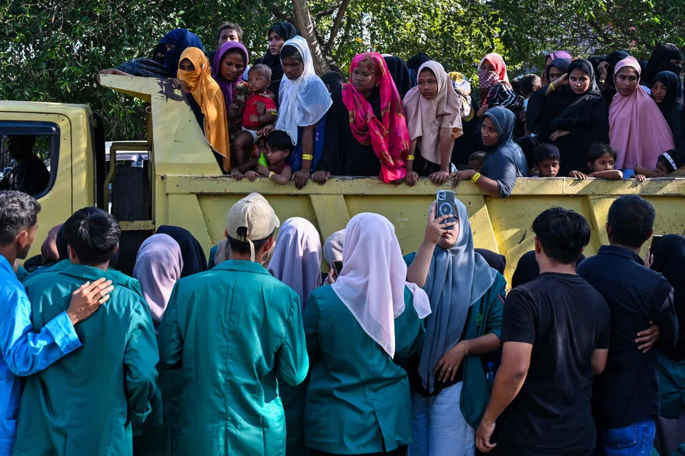 Rohingya refugees forced into a vehicle for relocation to a nearby government building after demonstrating university students forced them out of a government facility in Banda Aceh.