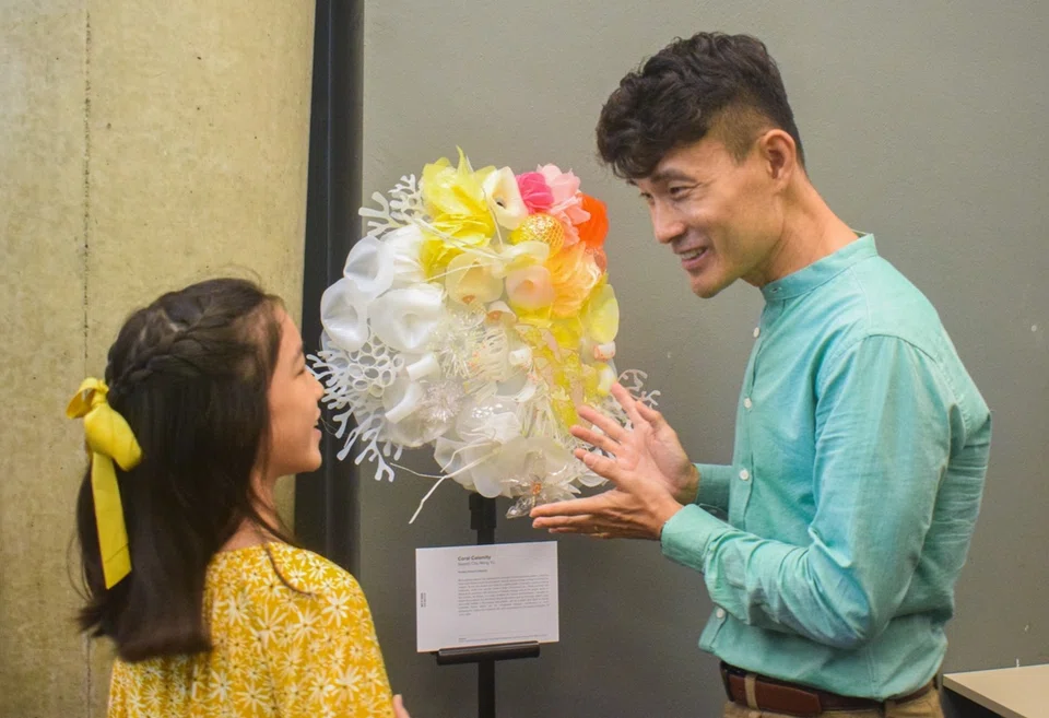 Senior Parliamentary Secretary for Sustainability and the Environment Baey Yam Keng (right) with Naomi Chu, the first-prize winner in the Primary School category of the Art of Trash Competition.