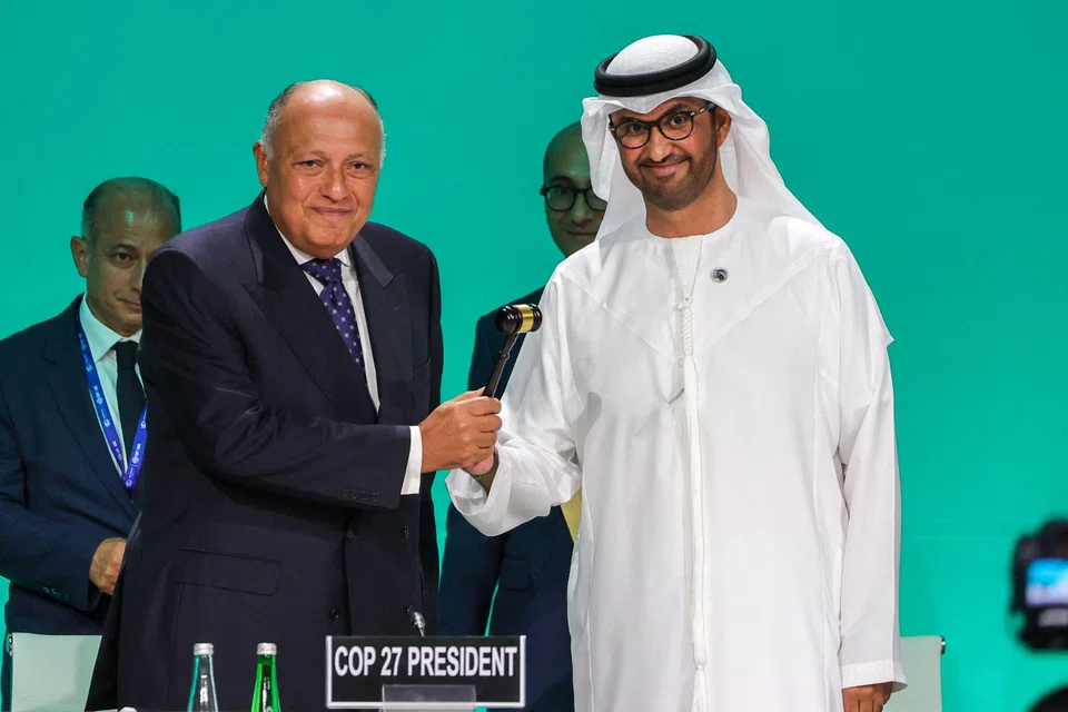 COP27 president Sameh Shoukry (L) hands over the gavel to COP28 president Sultan Ahmed Al Jaber during the opening ceremony of the COP28 UN climate summit in Dubai on Nov 30, 2023. 