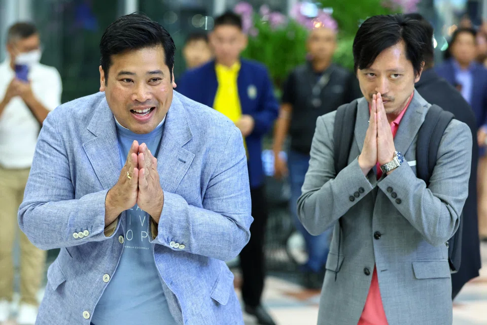 Vacharaesorn (L) and Chakriwat Vivacharawongse, Thailand's King Maha Vajiralongkorn's sons, greet members of the media at Bangkok's Suvarnabhumi international airport as they head back to the United States after a surprise visit to the kingdom after living abroad for 27 years.