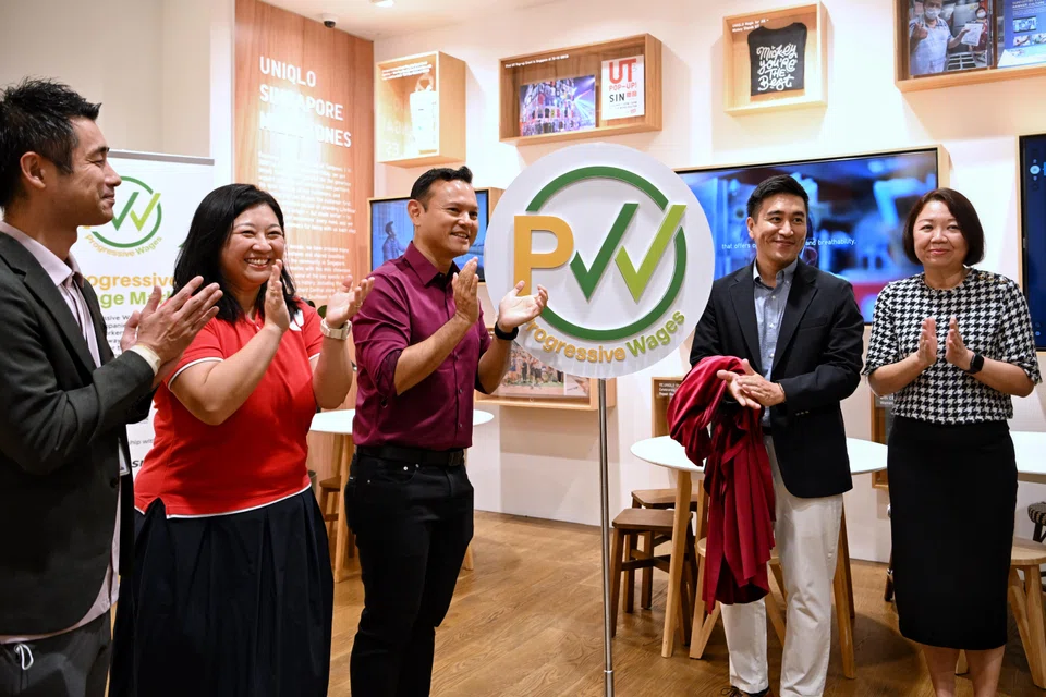 (From left) Suzuki Atsushi, general manager, Orchard Central Global Flagship Store, Uniqlo Singapore; Yeo Wan Ling, director, U SME and Women & Family Unit, NTUC; Zaqy Mohamad, Senior Minister of State for Manpower; Kuroda Yusuke, operations director, Uniqlo Singapore; and Tan Hwee Bin, honorary treasurer, Singapore National Employers Federation, at the launch of the PW Mark at the Uniqlo Flagship Store Orchard Central on Wednesday.