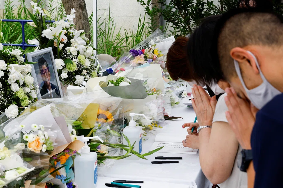 Mourners pray for late former Japanese Prime Minister Shinzo Abe, who was shot while campaigning for a parliamentary election, at Headquarters of the Japanese Liberal Democratic Party in Tokyo, Japan on July 12, 2022.


