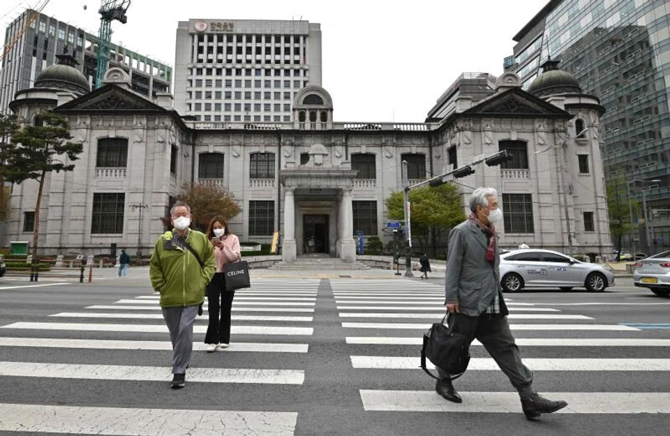 Above: Pedestrians crossing the road in front of the Bank of Korea. The South Korean central bank unexpectedly raised its policy rate by 25 basis points to 1.5 per cent in April. 
