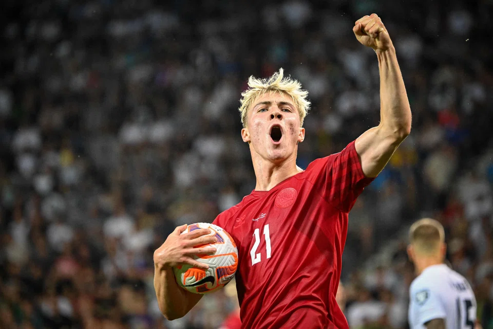 Manchester United's new striker Rasmus Hojlund celebrating after scoring a goal for Denmark against Slovenia in June. 