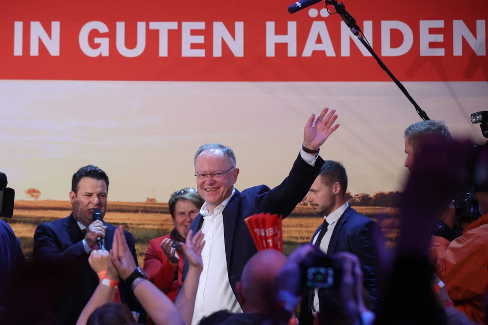 Stephan Weil, State Premier of Lower Saxony and leader of the Social Democratic Party (SPD) in Lower Saxony celebrates with supporters and German Minister of Labour and Social Affairs Hubertus Heil (left) after exit polls were announced on ZDF public broadcaster TV in Hanover, Germany. Oct 9, 2022. 