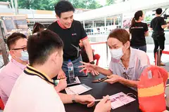 Han Kwee Juan (centre), acting chief information officer and Singapore country head, DBS, interacting with participants at the digital literacy workshop.