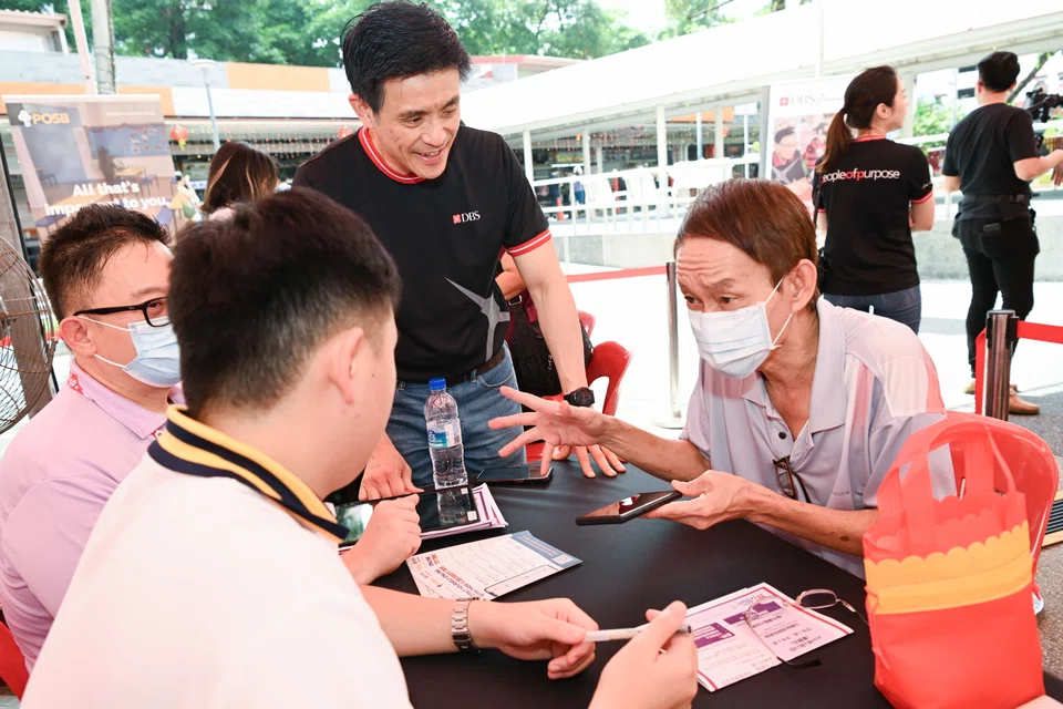 Han Kwee Juan (centre), acting chief information officer and Singapore country head, DBS, interacting with participants at the digital literacy workshop.