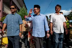 Analysts expect Malaysian PM Anwar Ibrahim (centre) to take a populist approach in policy-making, to regain the support of Malay voters.