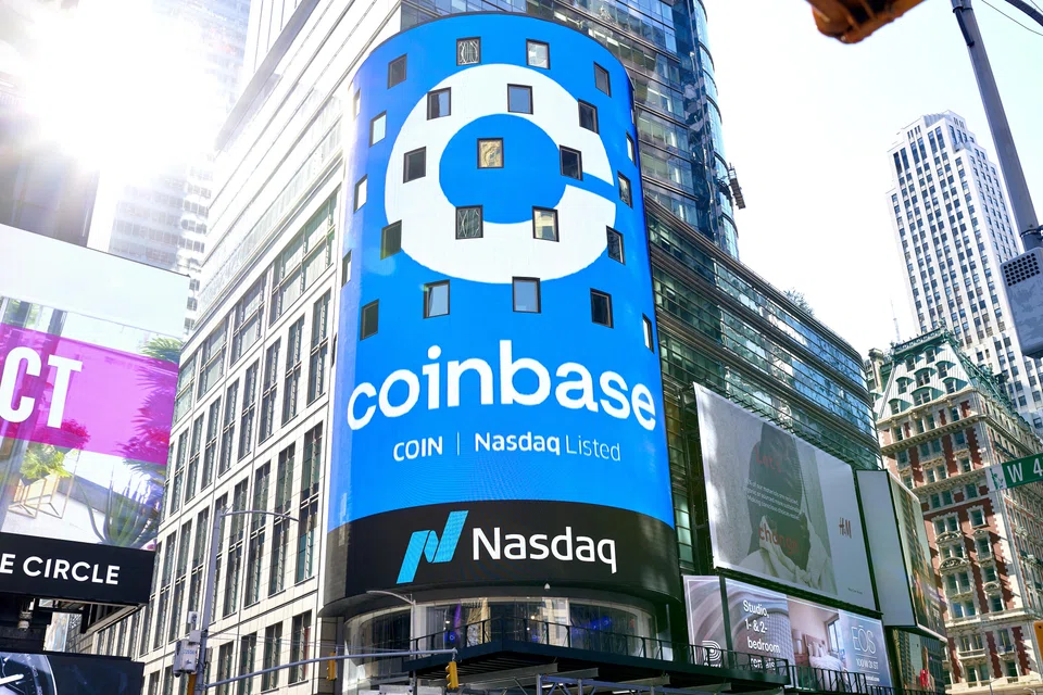 FILE Ñ The initial public offering of the cryptocurrency trading platform Coinbase is promoted at the Nasdaq stock exchange in Times Square in New York on April 14, 2021. Coinbase is laying off about 950 people, about a fifth of its staff, chief executive Brian Armstrong said in a memo to staff on Jan. 10, 2023. (Gabby Jones/The New York Times)