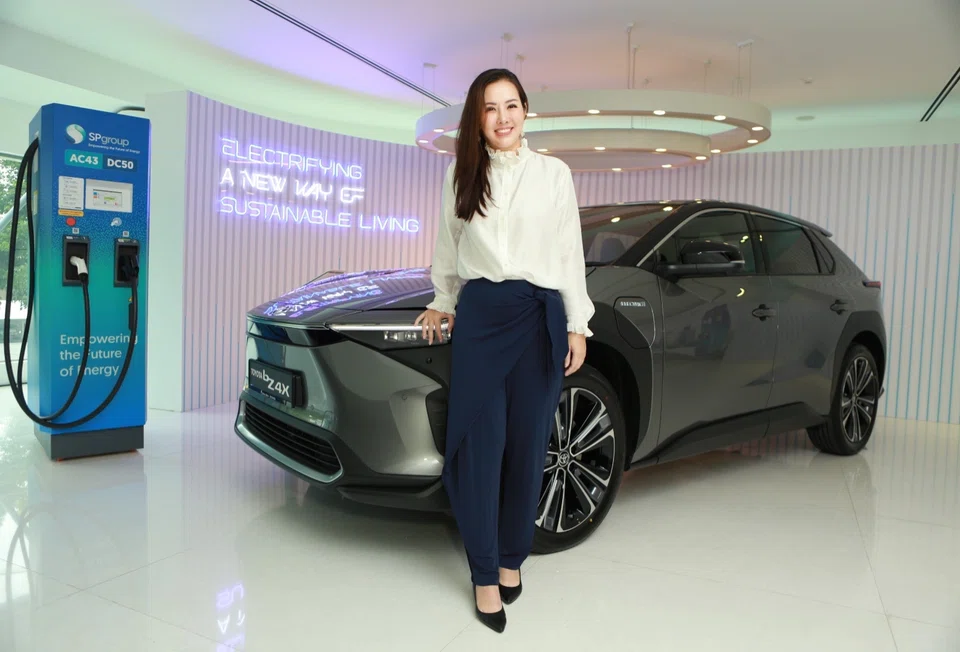 Inchcape Singapore and Greater China CEO Jasmmine Wong with the Toyota bZ4X, one of the cars that will be used for the car-sharing scheme at Tengah.