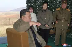 North Korean leader Kim Jong Un, with his wife Ri Sol Ju and their daughter, speaks on the day of the launch of an intercontinental ballistic missile (ICBM) in this undated photo released on Nov 19, 2022 by North Korea's Korean Central News Agency.