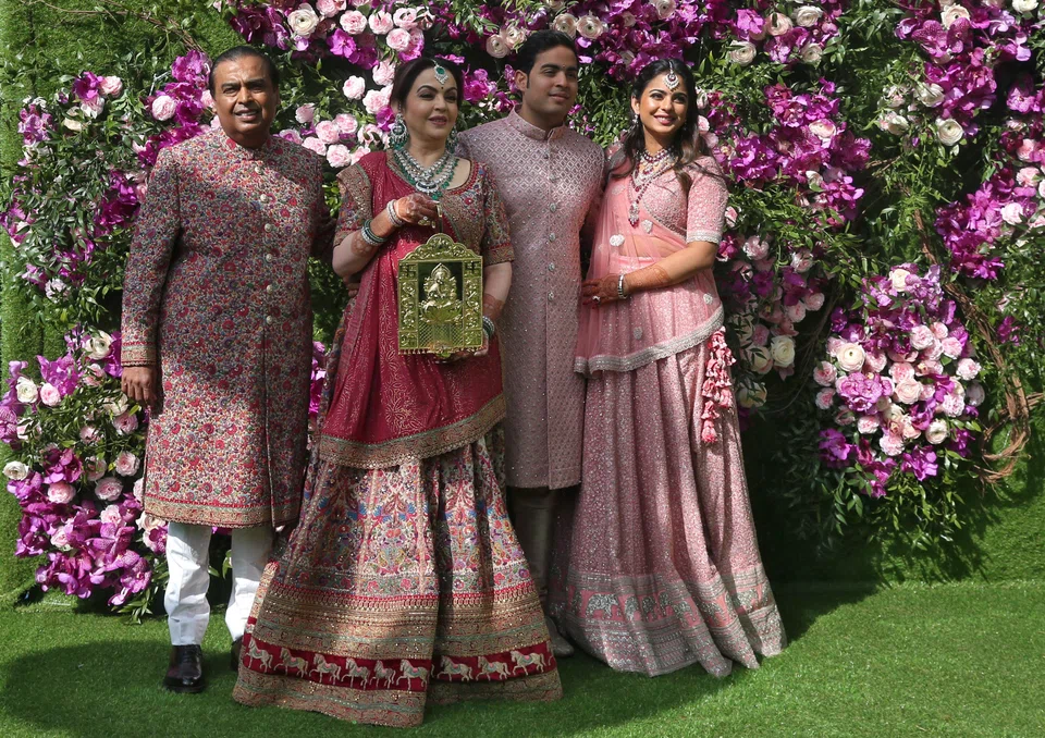 (L-R) Mukesh Ambani, the Chairman of Reliance Industries, his wife Nita Ambani, their son Akash Ambani and daughter Isha Piramal pose during a photo opportunity at the wedding ceremony of Akash, at Bandra-Kurla Complex in Mumbai, India, March 9, 2019. 
