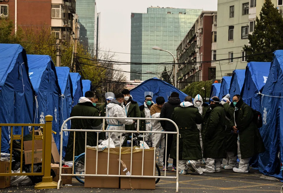 Security personnel wearing Personal Protective Equipment (PPE) at a residential area under lockdown due to Covid-19 coronavirus restrictions in Beijing.