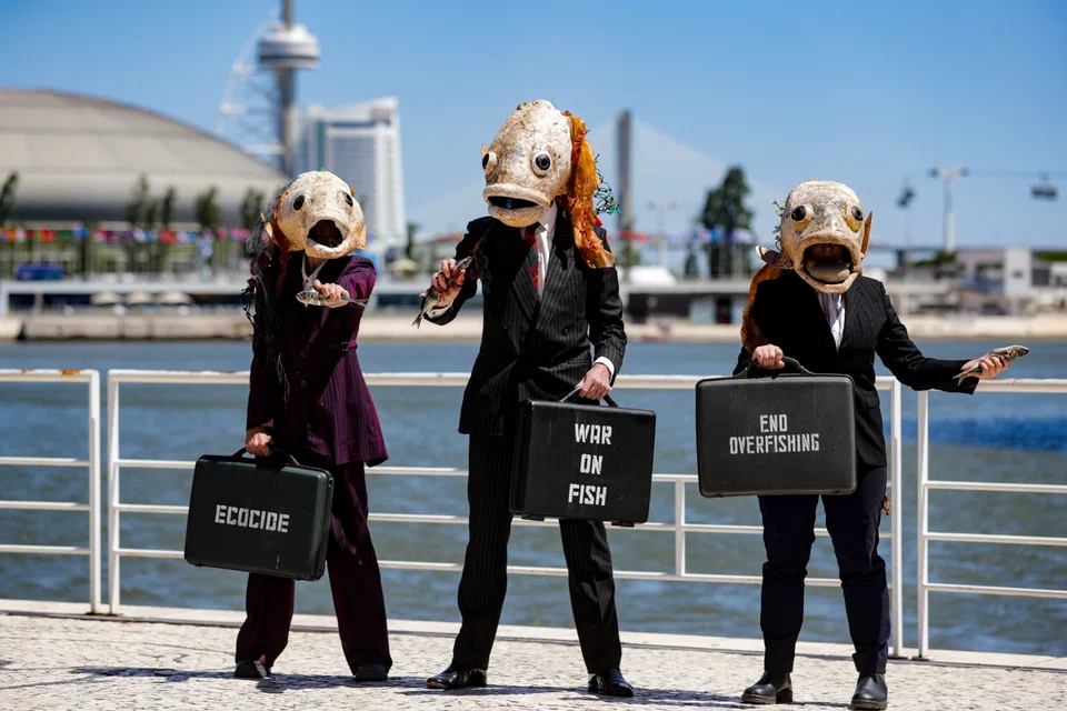 Environmental activists from Ocean Rebellion wearing fish heads and pinstripe suits call on UN delegates and world leaders to use their power and influence to end the war on fish and govern for life in the ocean. The UN Ocean Conference opened in Lisbon, Portugal, on Monday (Jun 27).