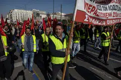 In Athens, thousands of people marched in the second 24-hour walkout this year over rising inflation, some holding up banners that read, “No to layoffs, no to pay cuts.”